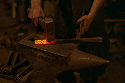 Close-up of man working on metal