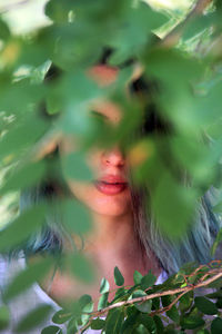 Close-up of woman amidst branches