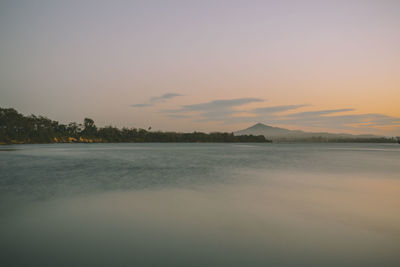 Scenic view of lake against sky at sunset