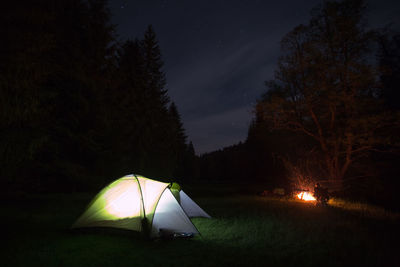 Illuminated tent against sky at night