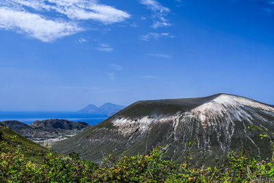 View of volcanic mountain against blue sky