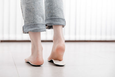 Low section of woman standing on floor