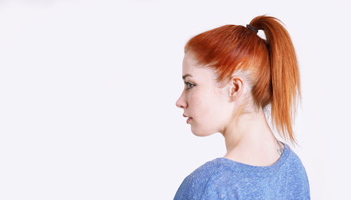 Close-up of young woman against white background