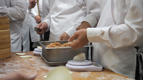 Midsection of man preparing food