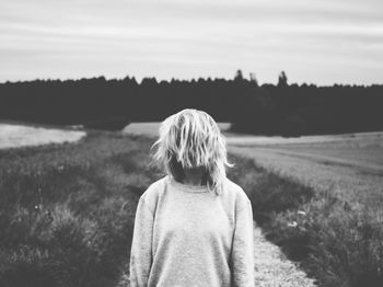 Woman on field against sky