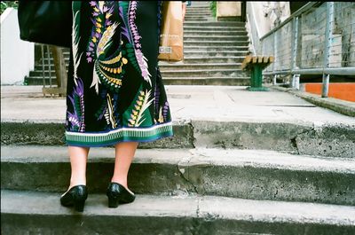 Low section of woman standing on street