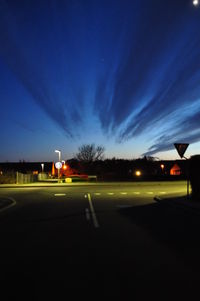 View of illuminated road at night