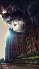 Low angle view of buildings against cloudy sky