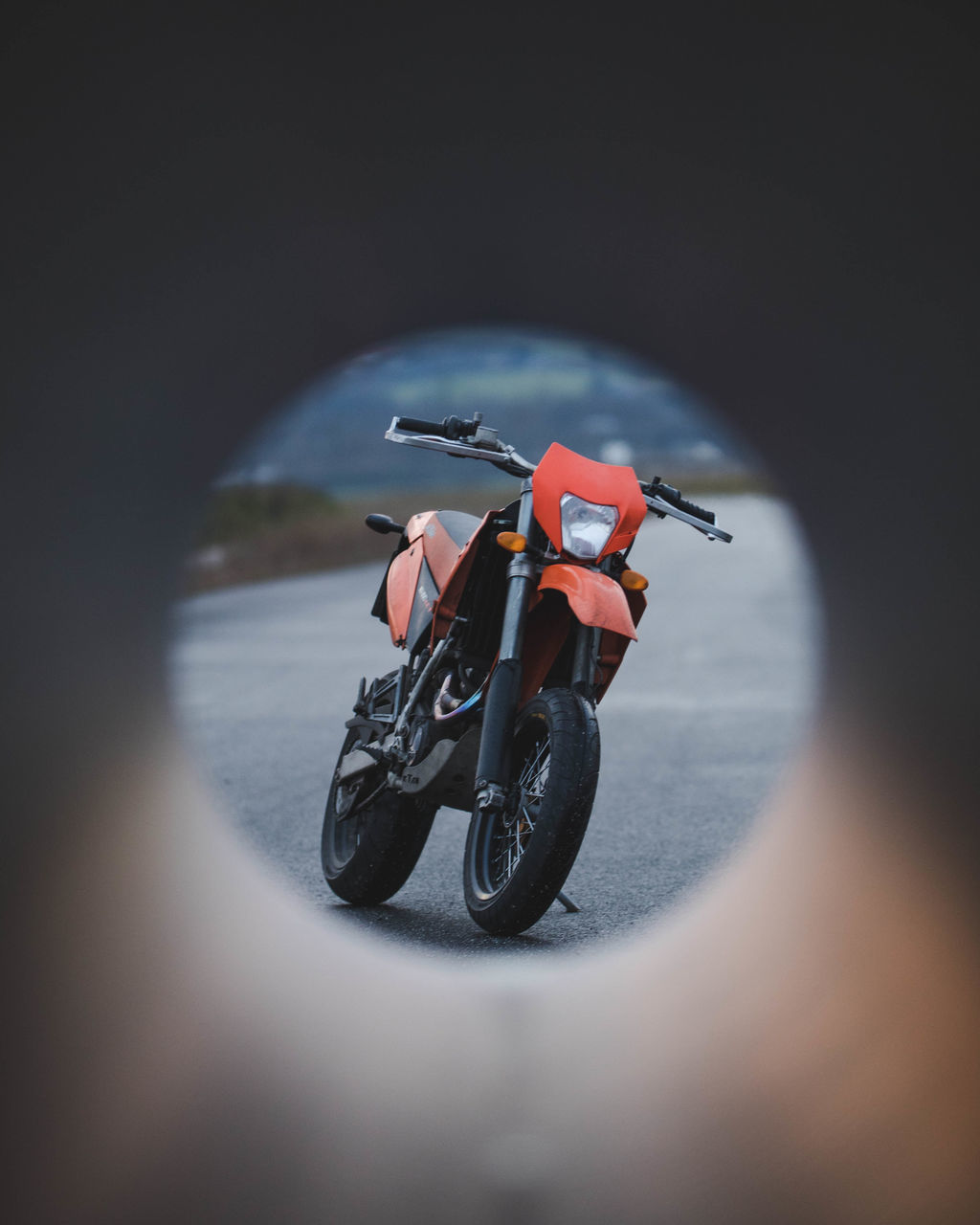 MAN RIDING MOTORCYCLE ON ROAD