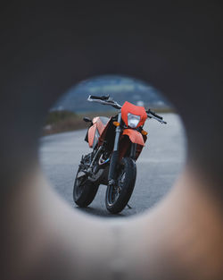 Close-up of man riding motorcycle on road