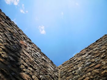 Low angle view of rock formation, wall against sky