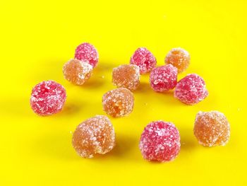 Close-up of candies against yellow background