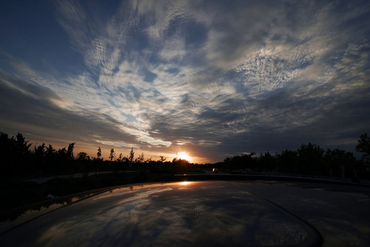 sunset, sky, road, cloud - sky, transportation, cloudy, silhouette, tranquil scene, the way forward, tranquility, scenics, street, cloud, beauty in nature, nature, dramatic sky, tree, car, road marking, landscape