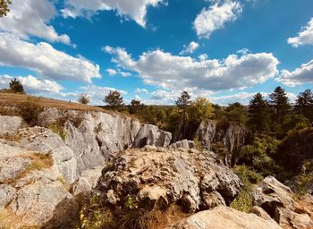 Rock formations on landscape against sky