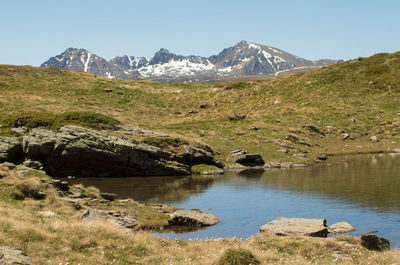 Scenic view of lake and mountains against clear sky