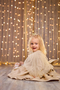 Portrait of young woman sitting at home