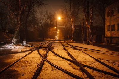 Empty railroad tracks at night during winter