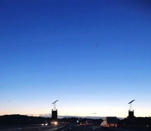 Silhouette of city against clear blue sky