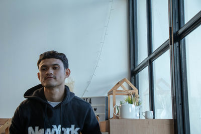 Portrait of young man at home