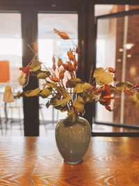 Close-up of flower vase on table at home