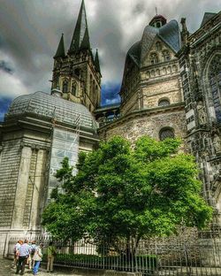 Low angle view of church against cloudy sky