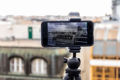Close-up of digital camera in city