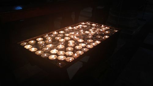 High angle view of illuminated lights in dark room