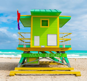 Lifeguard hut on beach against sky