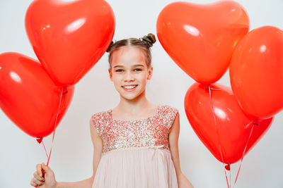 Portrait of woman with red balloon