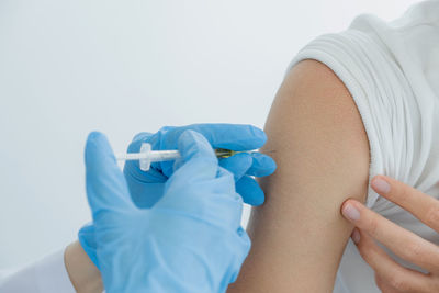 Doctor vaccinated patient against white background