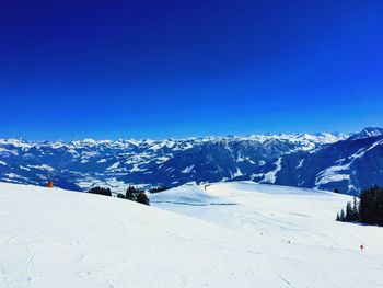 Scenic view of snowcapped mountains against clear blue sky