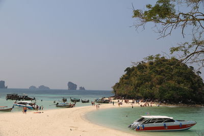 Panoramic view of people on beach against sky