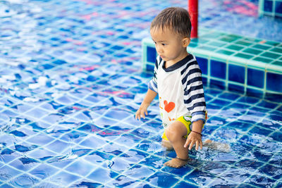 High angle view of cute boy in swimming pool