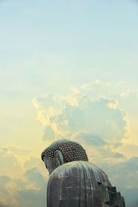 Superimposed of the great buddha of kamakura town, japan with dramatic and peaceful clouds.