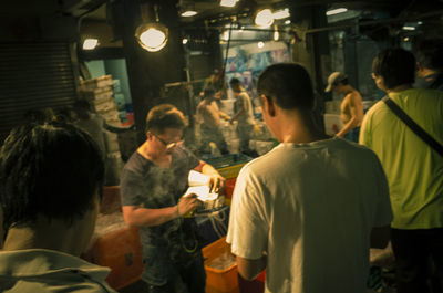 Rear view of people standing in restaurant