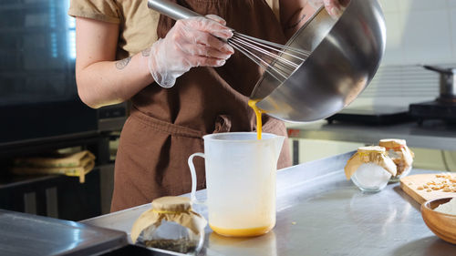 Midsection of man preparing food on table