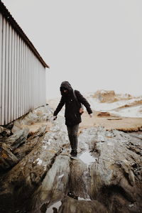 Full length of man standing on rock