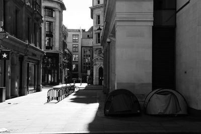 Empty street amidst buildings in city