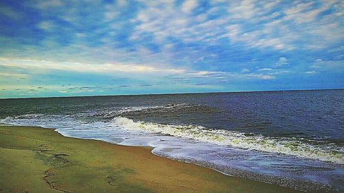 Scenic view of sea against cloudy sky