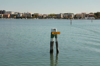 Scenic view of sea against buildings in city