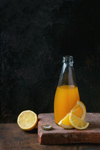 Oranges with juice on table