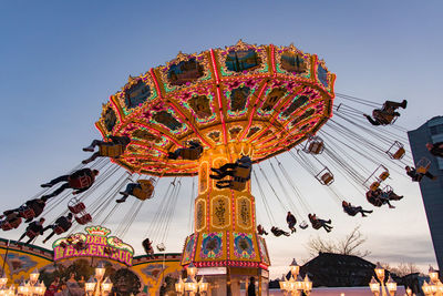 Low angle view of illuminated ferris wheel against sky