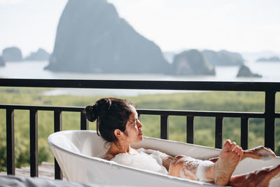 Woman relaxing in bathtub