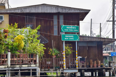 Information sign by building in river in bangkok