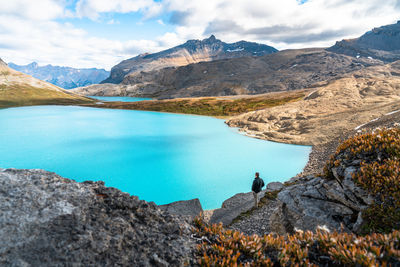 Hiker watching sunrise at michelle lakes clearwater county wilderness