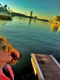 High angle view of boy sitting on riverbank