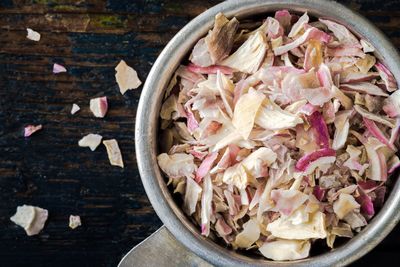 Directly above shot of dried shallots in measuring spoon on table