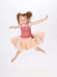 Happy girl jumping against white background