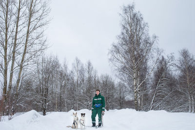 Full length of man with dogs during winter