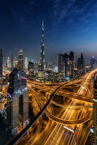 Aerial view of illuminated city buildings at night